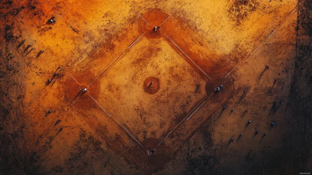 Baseball wallpaper 4k with an aerial view of the infield under sunset.