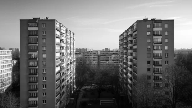 Black and white buildings stretch to the horizon with crisp shadow play.