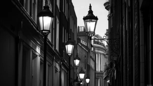 Black and white city wallpaper of London with historic charm and street lights.