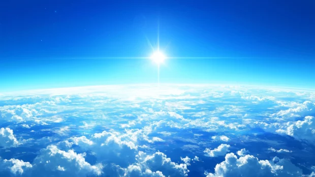 Center float of single fluffy white cloud in vibrant blue sky.