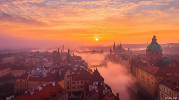 City waking up under a soft peach colored sunrise.