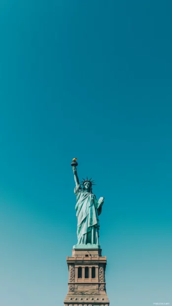 Clean shot of Statue of Liberty, clear blue sky behind.