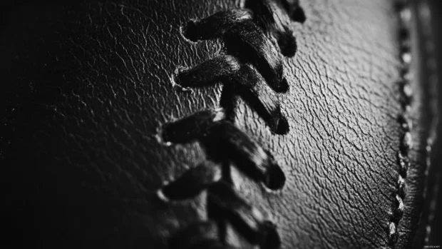 Close up of baseball stitches with film grain and shadow, Classic black and white baseball portrait.