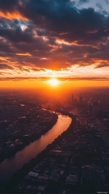 Clouds reflecting first light above a cityscape in a Sunrise Wallpapers for Android.
