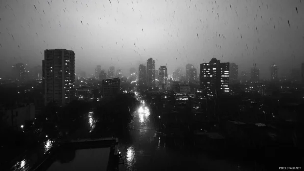 Dark urban skyline in heavy rain, perfect for raining city wallpaper.