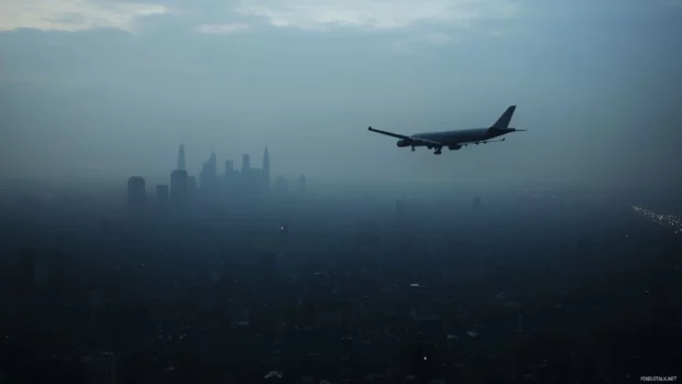 Distant planes fly over the black city horizon.
