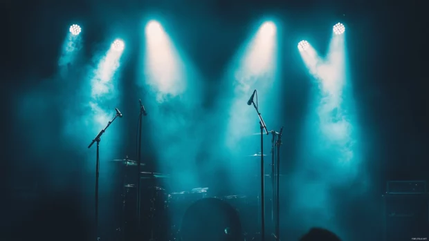 Dramatic stage lights powerful shot drum set black and silver finishes dynamic atmosphere heavy metal concert.