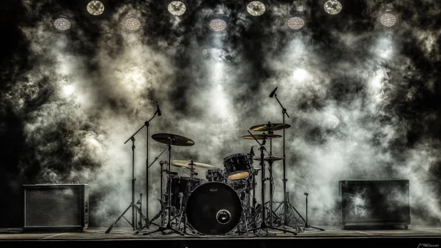 Drum set black and silver finishes powerful shot dramatic stage lights dynamic atmosphere heavy metal concert.