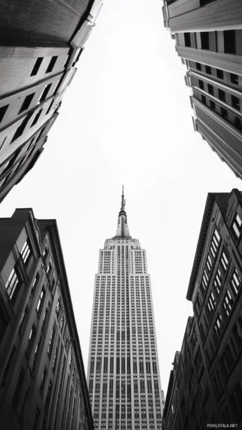 Empire State Building, simple, towers over nearby structures.
