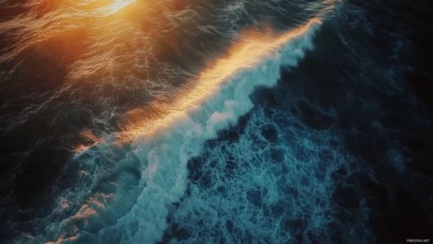 Layers of light and shadow play on ocean waves during sunrise.