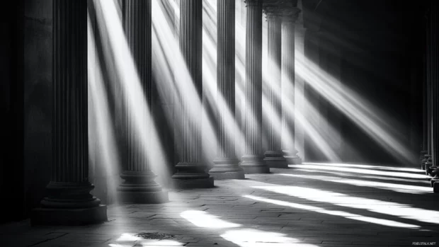 Light beams through alleyways in a classic grayscale setting.