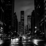 Midnight black city wallpaper featuring towering skyscrapers and dimly lit streets.