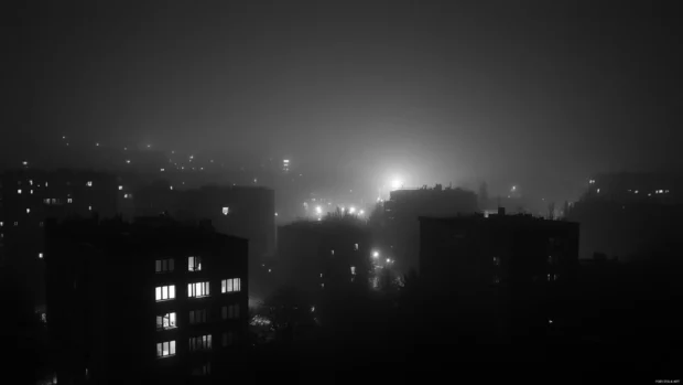 Midnight mist clinging to the corners of the black city.