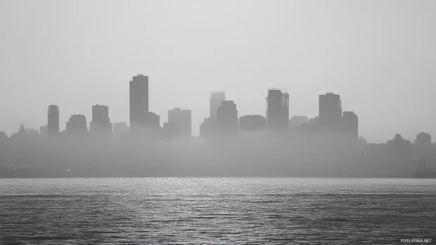 Morning haze settles over the monochrome urban skyline.
