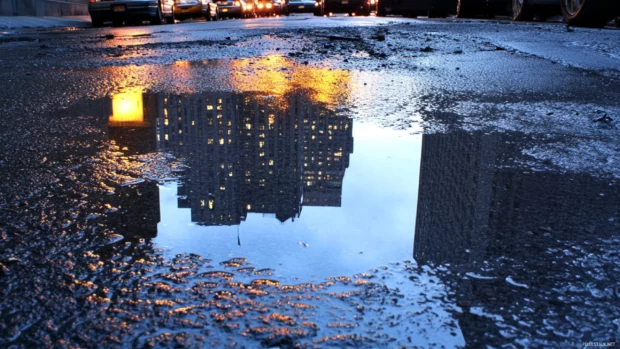 Night New York City Wallpaper highlighting reflections in wet pavement.