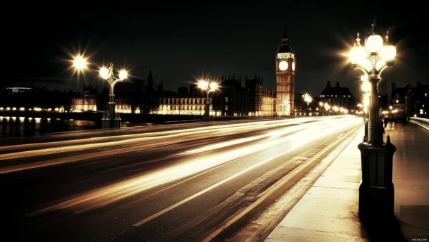 Nighttime city bridge with warm lights and motion blur.