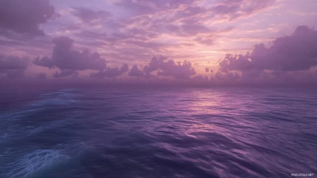 Ocean dreamy evening sky horizon glowing pastel pinks and lavenders gentle waves roll in.