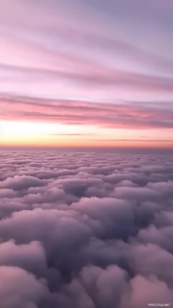 Pastel pink sky, fluffy clouds drift, smooth gradient to horizon.