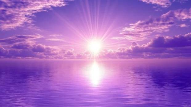 Pastel purple sky, light clouds, shimmer in sunset glow.