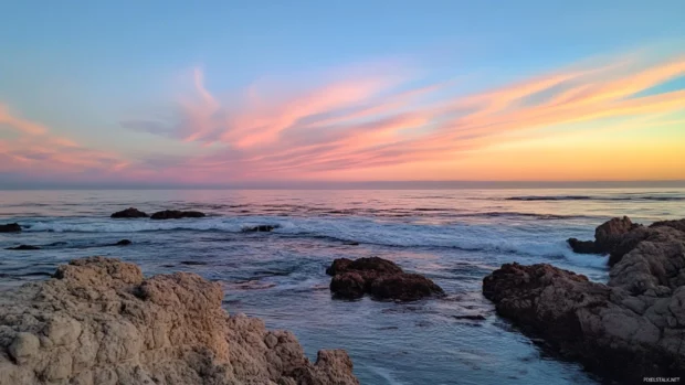 Pastel sky meets endless ocean at daybreak.