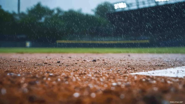 Rain falling on an empty baseball field.