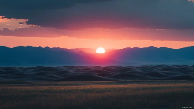 Rolling dunes meet the rising sun in a Sunrise Wallpaper in Desert.