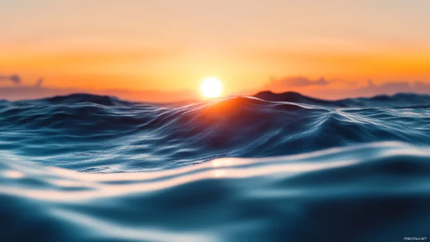 Serene ocean and rising sun meeting at the horizon, sunrise wallpaper over ocean.