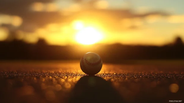 Shadow cast over a baseball as sun sets.