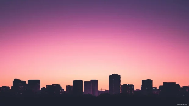 Silhouette of a city skyline at dusk with a soft gradient sky.