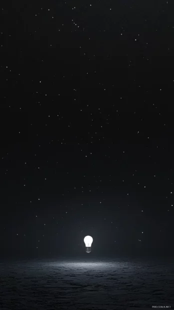 Single Light bulb in vast dark space.