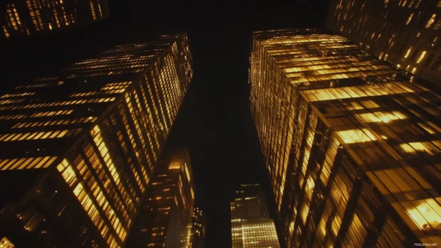 Skyscrapers shimmer in the night sky of New York City.
