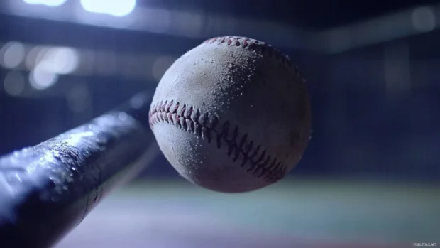 Slow motion of a baseball hitting the bat from close up.