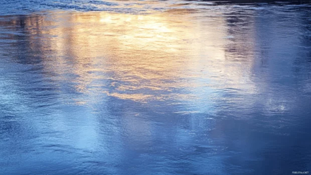 Soft clouds reflect the early sun over the water.