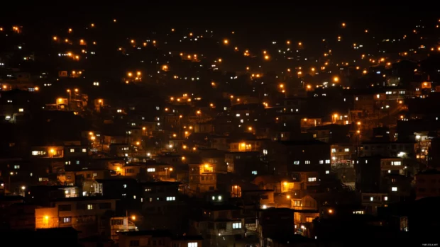 Soft glimmers of window lights scattered across the black city.
