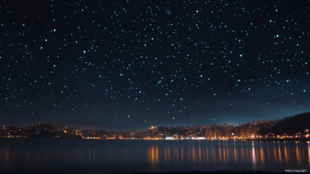 Starry backdrop and city lights captured in Night New York City Wallpaper.