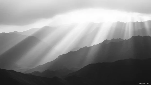 Sunlight trickles over ridges and rocks of the desert.