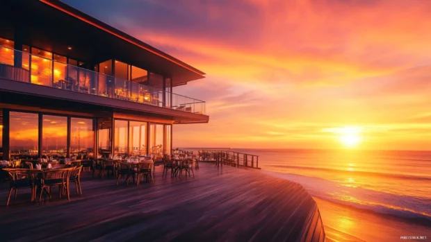 Sunset ocean view from beachside restaurant with soft lighting.