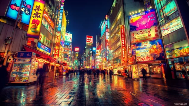 Tokyo Cityscape Wallpaper glowing with neon lights under a clear sky.
