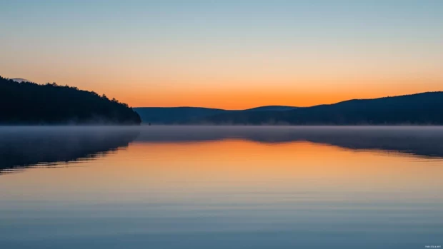 Tranquil waters bask in the warmth of sunrise.