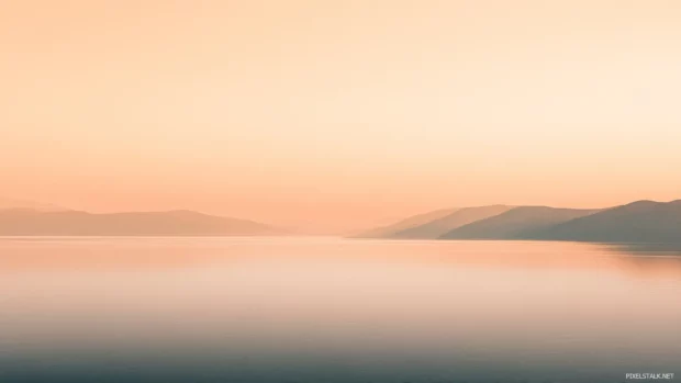Warm tones rise over the sea in this glowing Sunrise Wallpaper for Macbook.