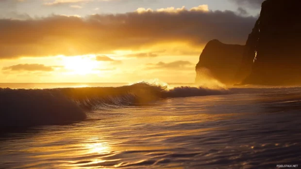Waves catching golden sunlight in peaceful Sunrise Wallpaper for Desktop.