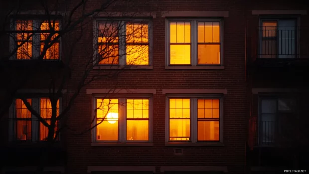 Windows glow with warmth across New York City skyline.