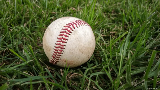 Zoomed shot of baseball seams spinning in air.