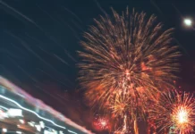 A Lamborghini Aventador racing under fireworks with a blurred background.