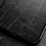 A black marble pattern lines the lock screen with natural textures and subtle glints.
