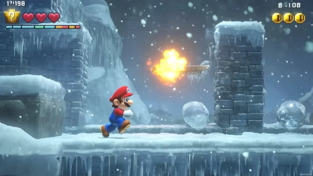 A blizzard sweeps across a frozen level as Mario uses fireballs to melt obstacles.
