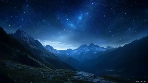 A breathtaking starry sky with thousands of twinkling stars spread across a deep blue and black gradient, with the Milky Way clearly visible in the distance.