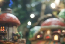 A cozy village background surrounds Mario and Luigi as they wave to cheering Toads.