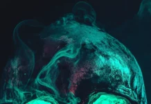 A dark aesthetic skull iPhone wallpaper with neon green lighting.