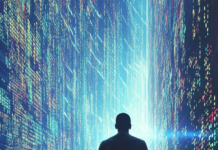 A figure in a light reflecting cape walks past a wall of streaming code.